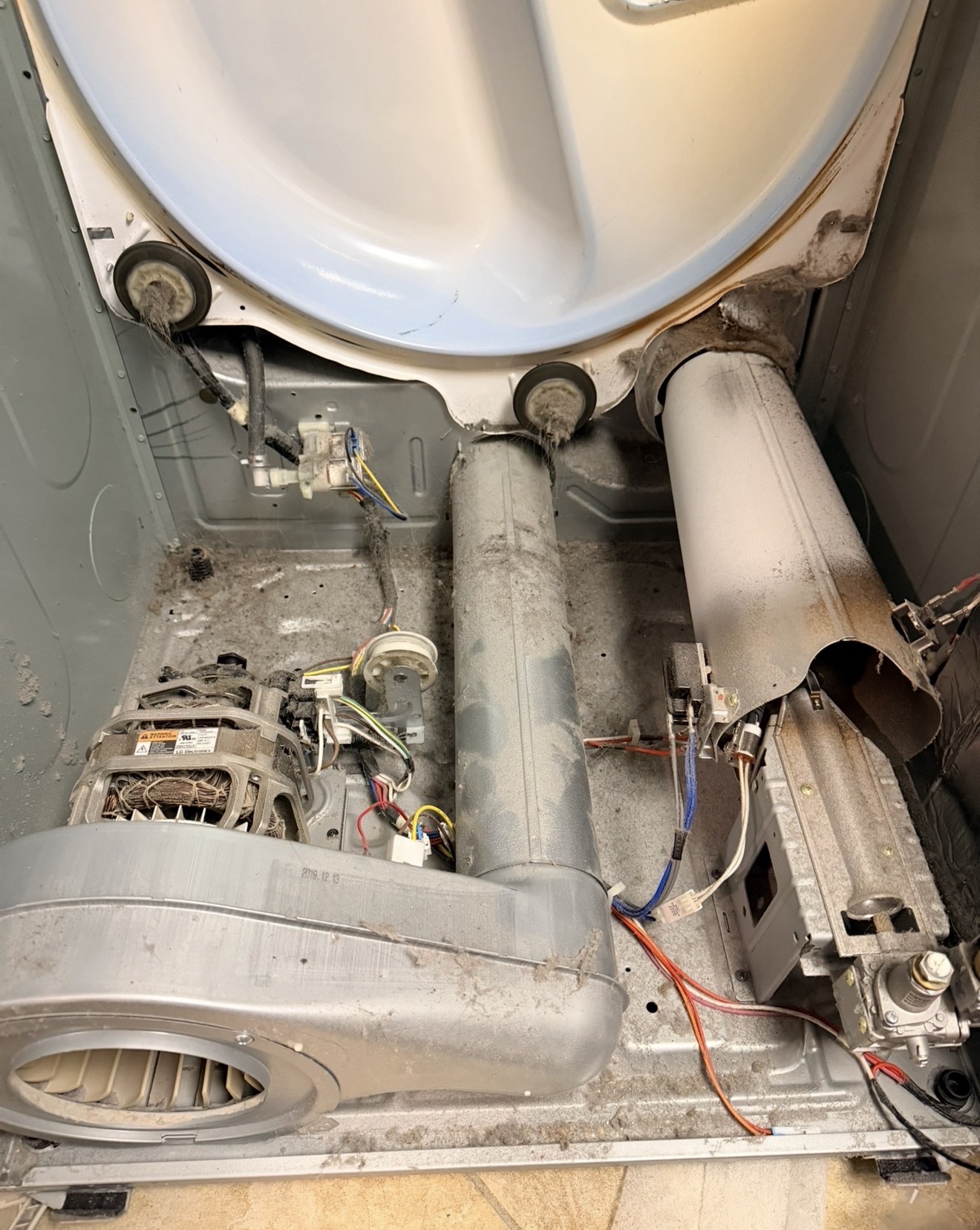 LG dryer internal view showing lint buildup around blower wheel and duct — d80 vent restriction cause in Great Kills 10308