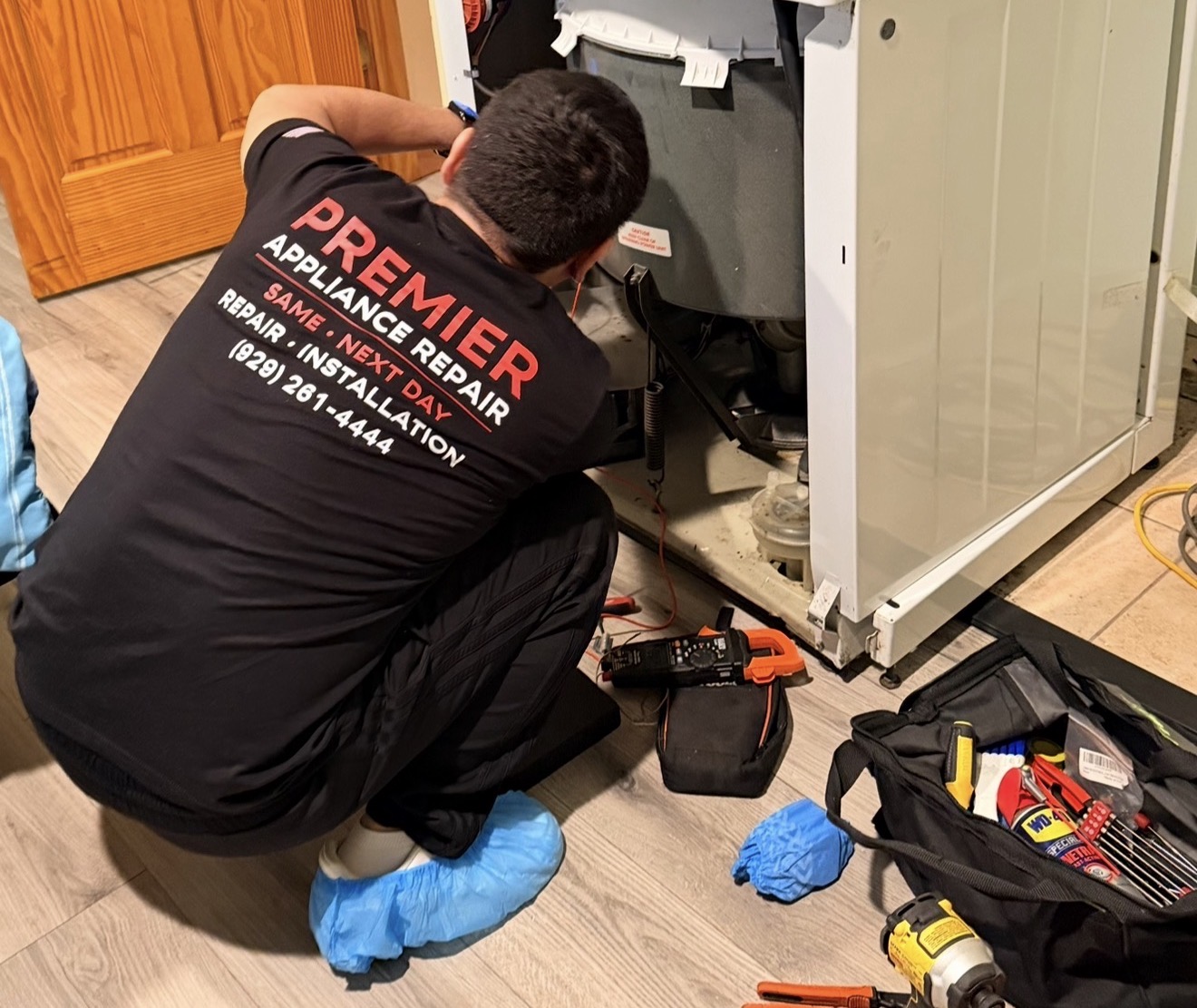 Badma Premier Appliance Repair technician working on Whirlpool washer Great Kills Staten Island 10308