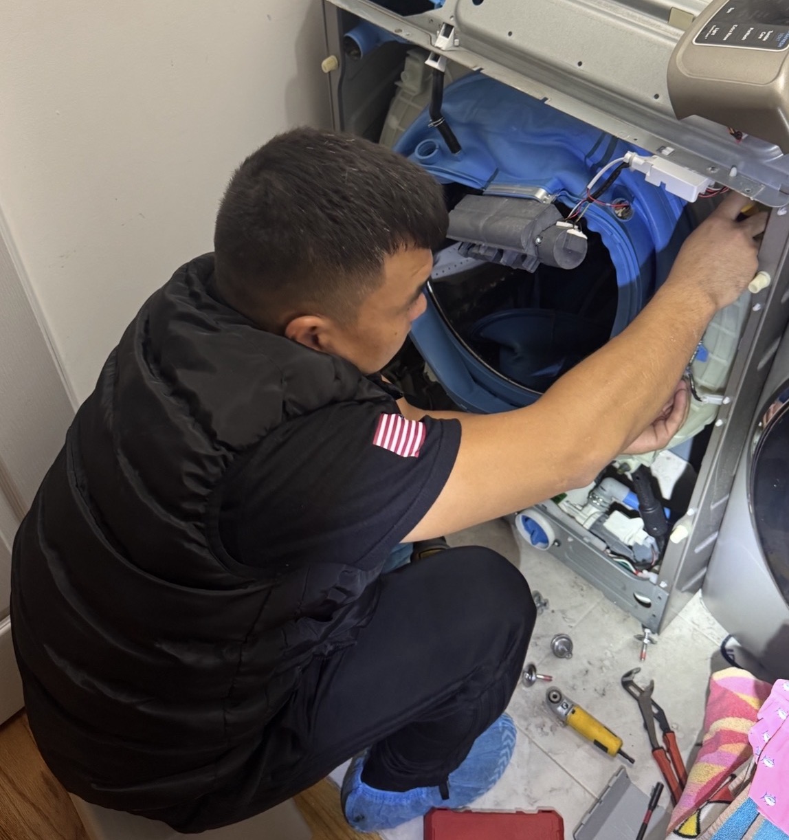 Premier Appliance Repair Staten Island technician fixing GE washer Staten Island